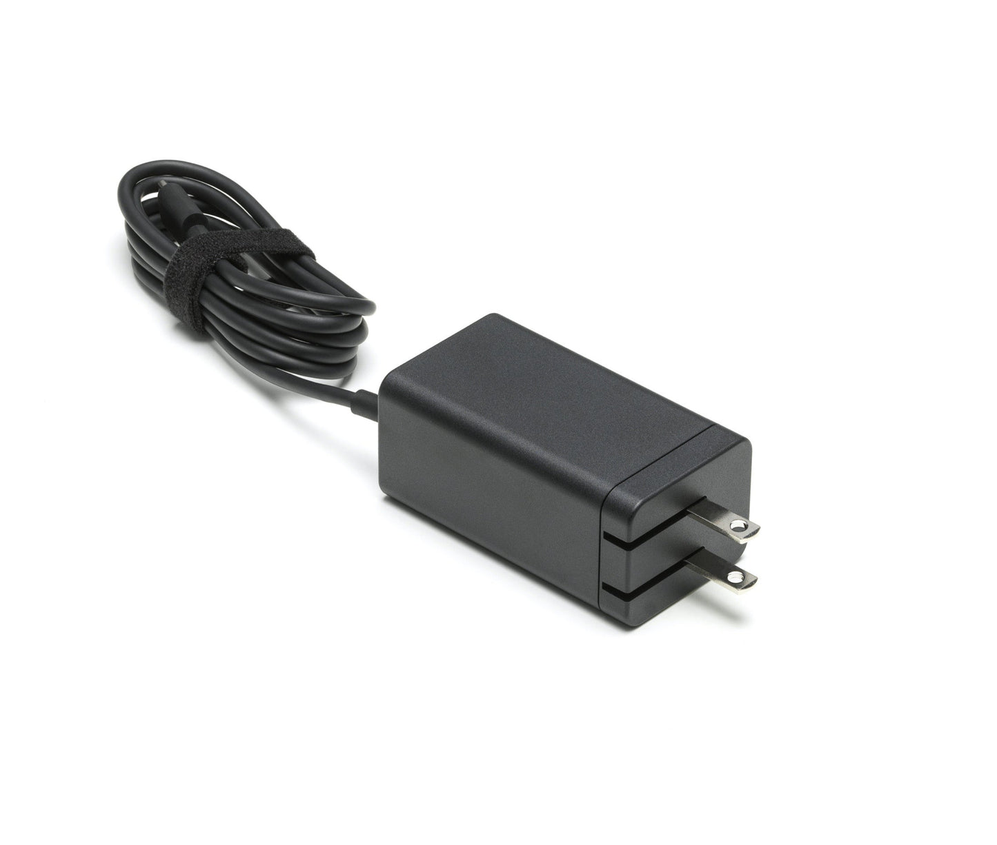 Black power adapter with a cable on a white background