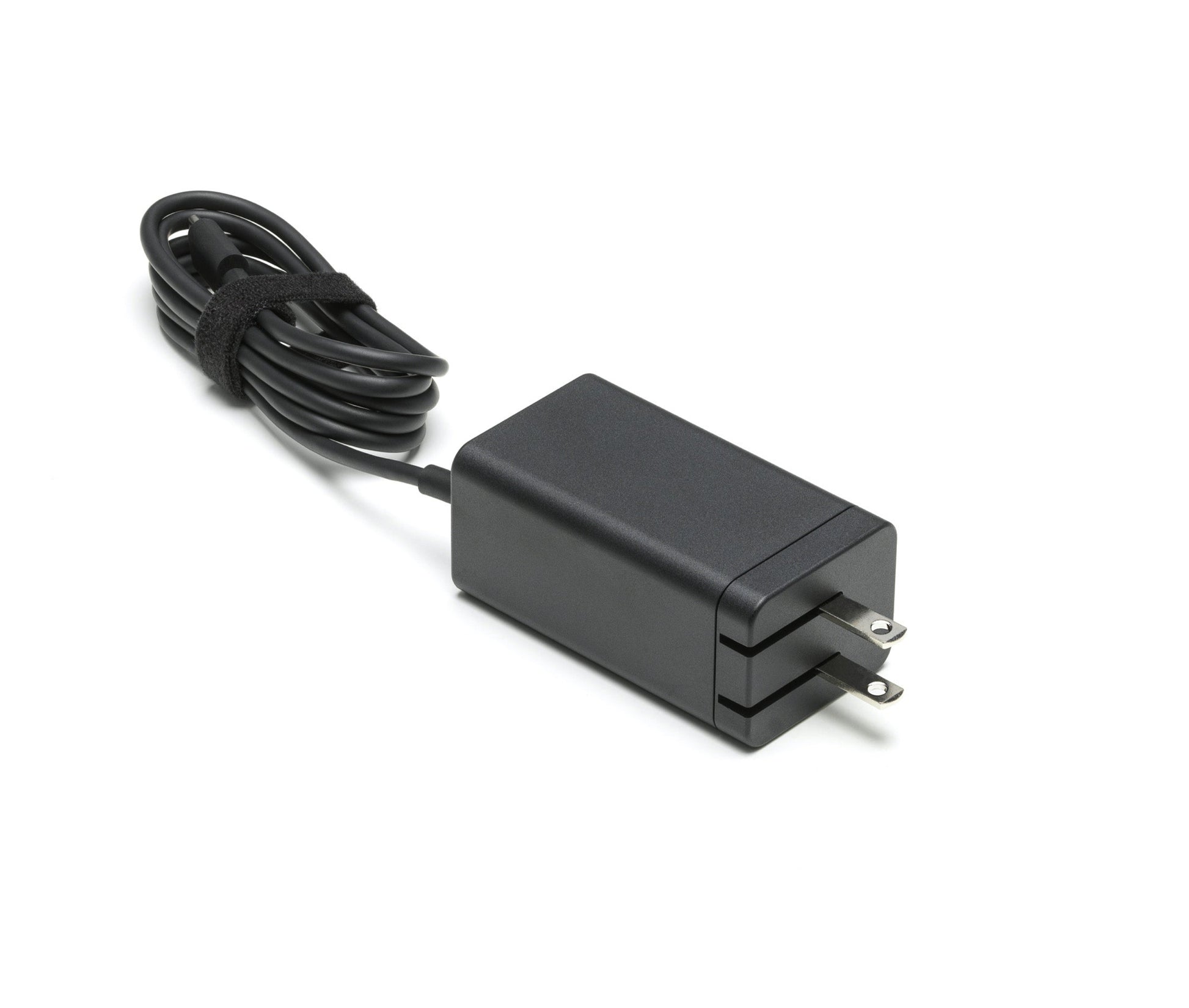 Black power adapter with a cable on a white background
