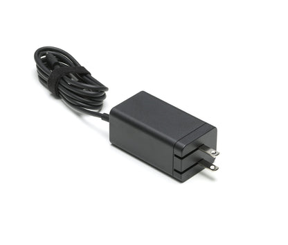 Black power adapter with a cable on a white background
