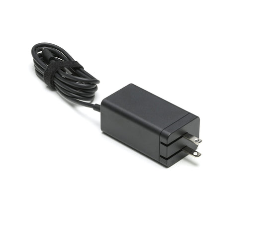 Black power adapter with a cable on a white background